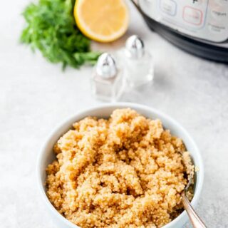 Top down view of a bowl of Lemon Quinoa with Instant Pot in the background.