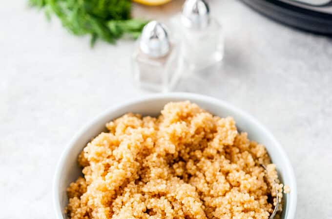 Top down view of a bowl of Lemon Quinoa with Instant Pot in the background.