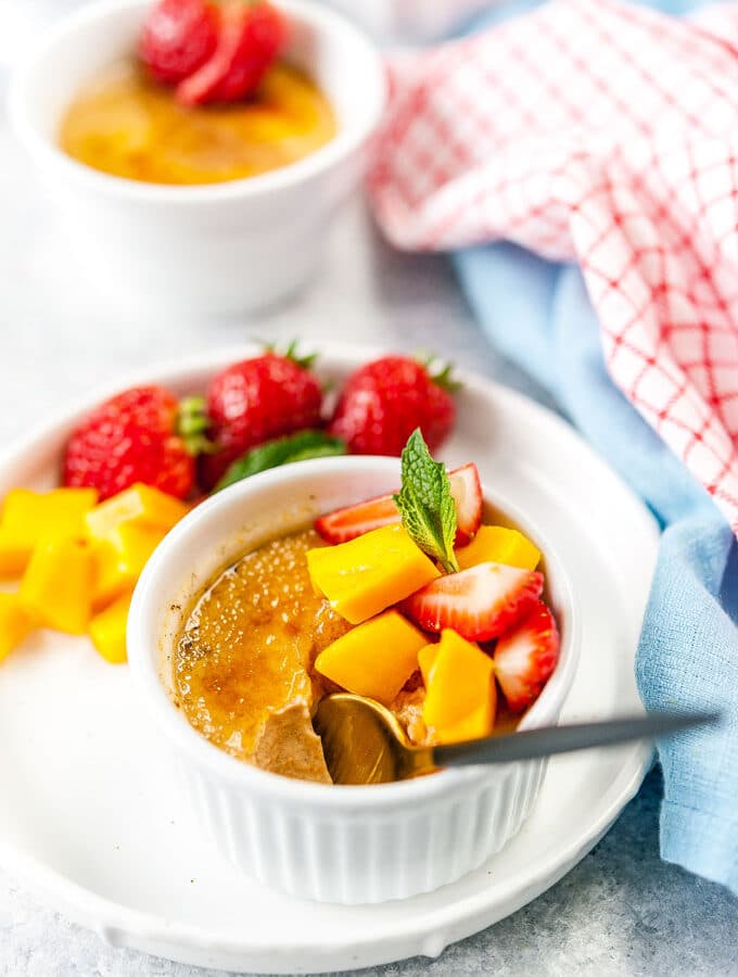 Spoon in a bowl with creme brulee.